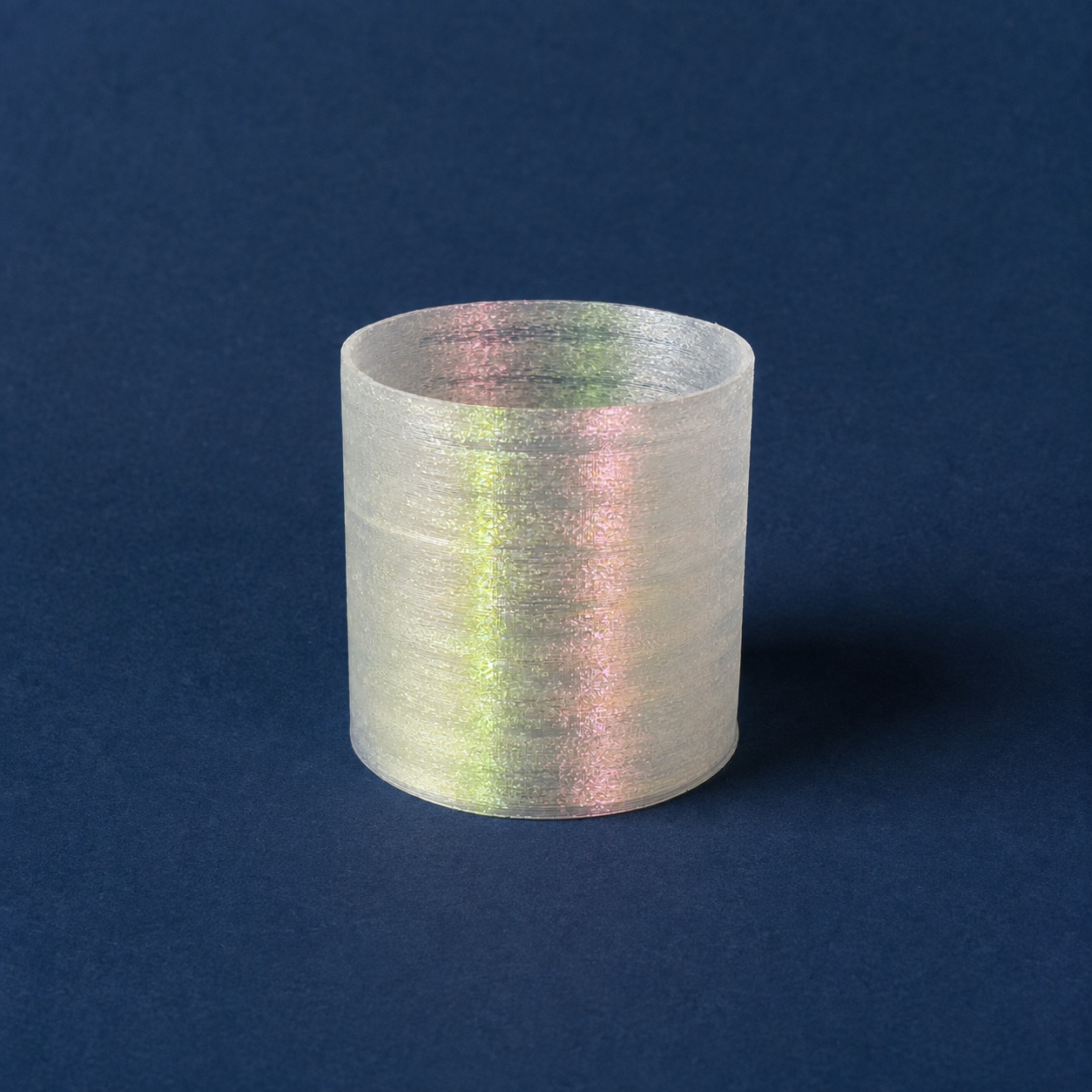 Printed vessel one from the side, translucent walls banded with colour